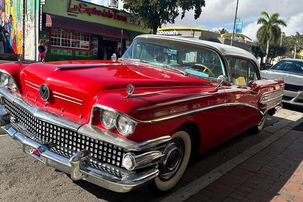 an old red car parked on the side of the street
