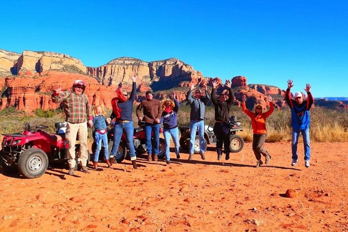 a group of people posing for a picture in the desert