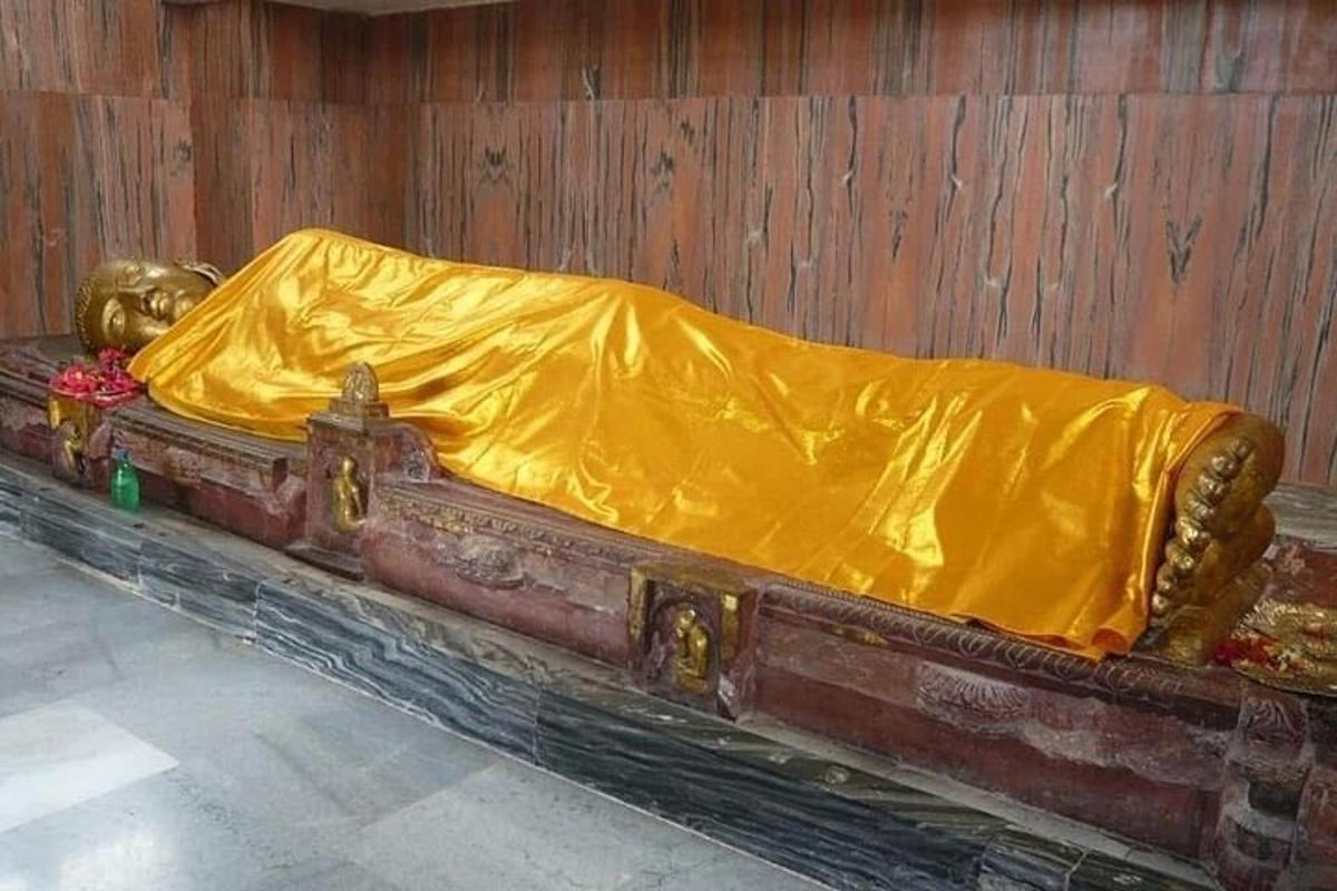 a bed with a yellow blanket on top of it