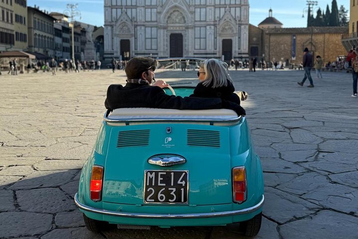 two people sitting in the back of a car