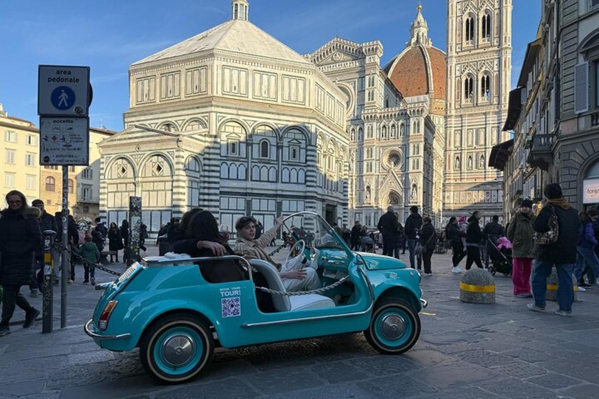 a group of people riding in a blue car