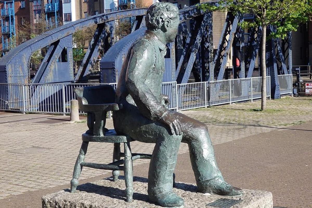 a statue of a boy sitting in a chair