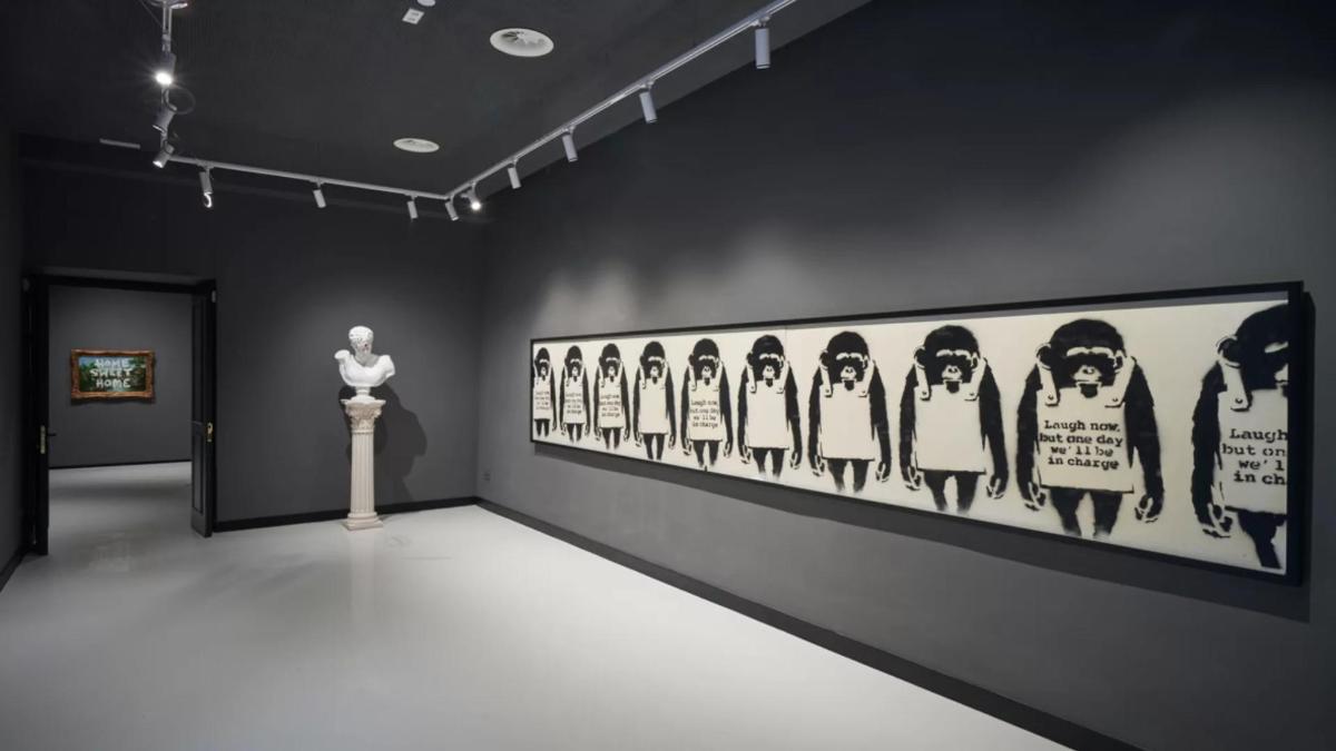 a museum exhibit with a statue and a painting