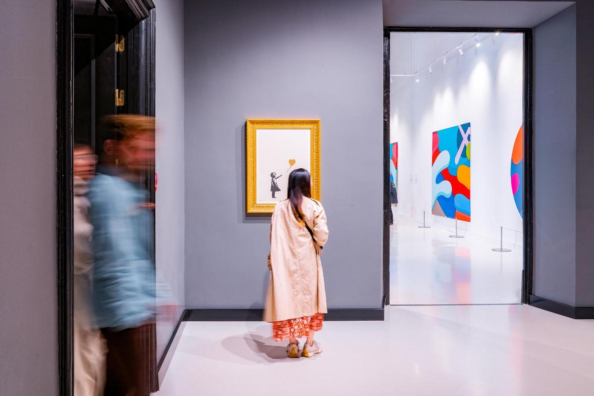 a woman is looking at art in a museum