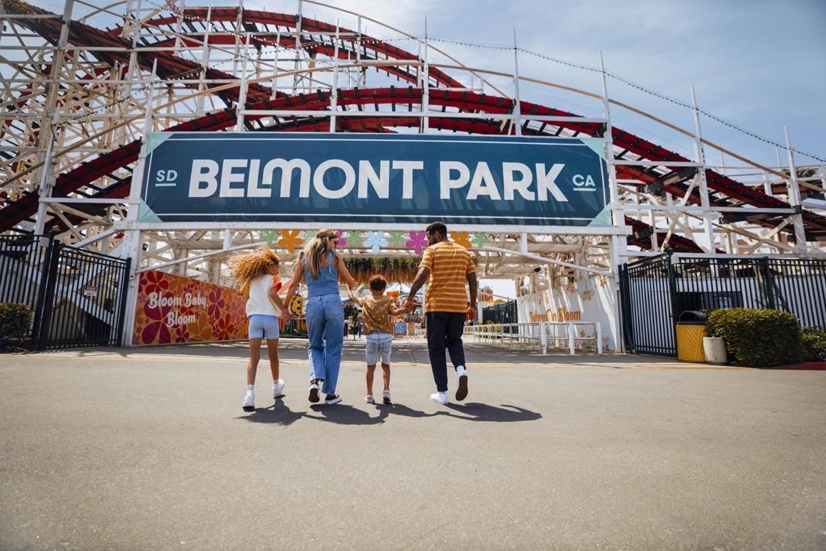 a family standing under a sign at a stadium
