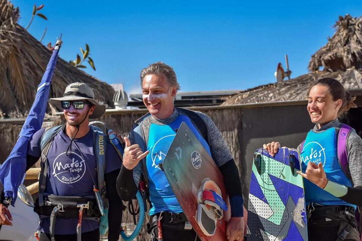 three people standing next to each other holding surfboards