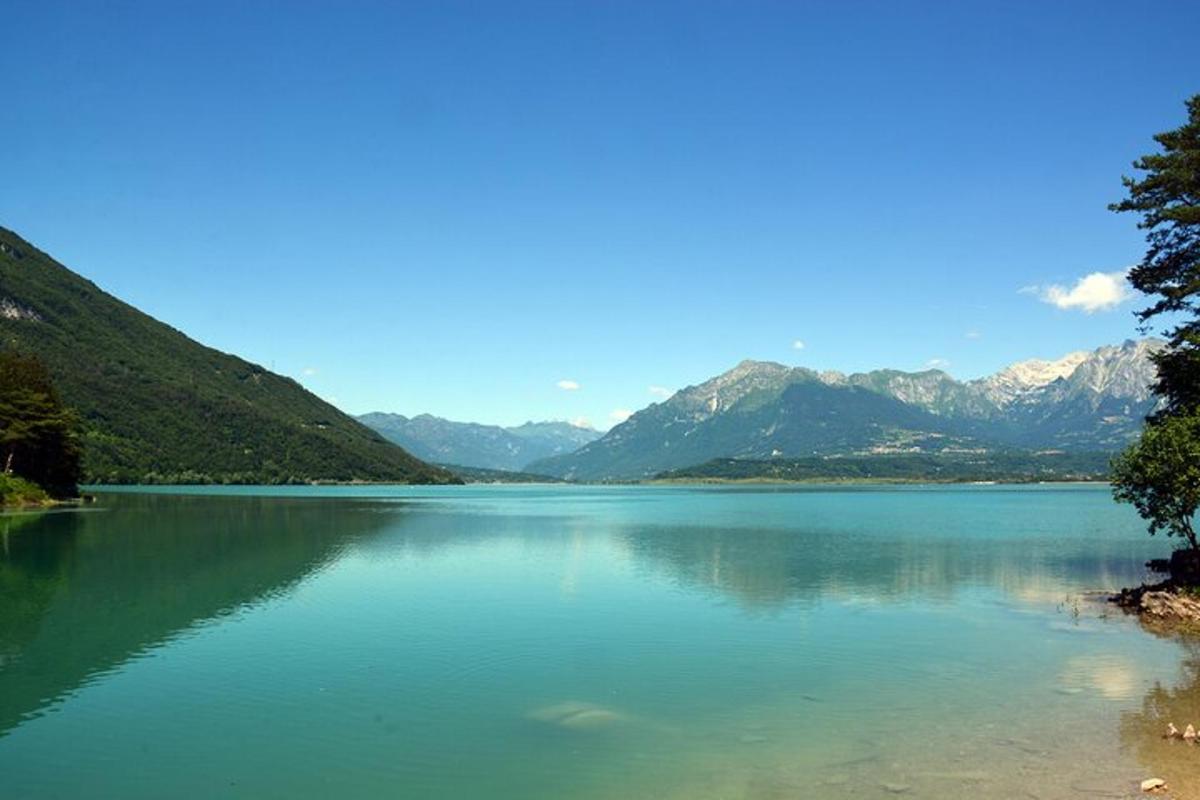 a large body of water with mountains in the background