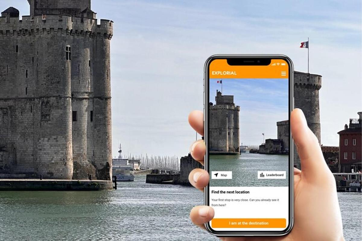 a person holding up a cell phone in front of a castle