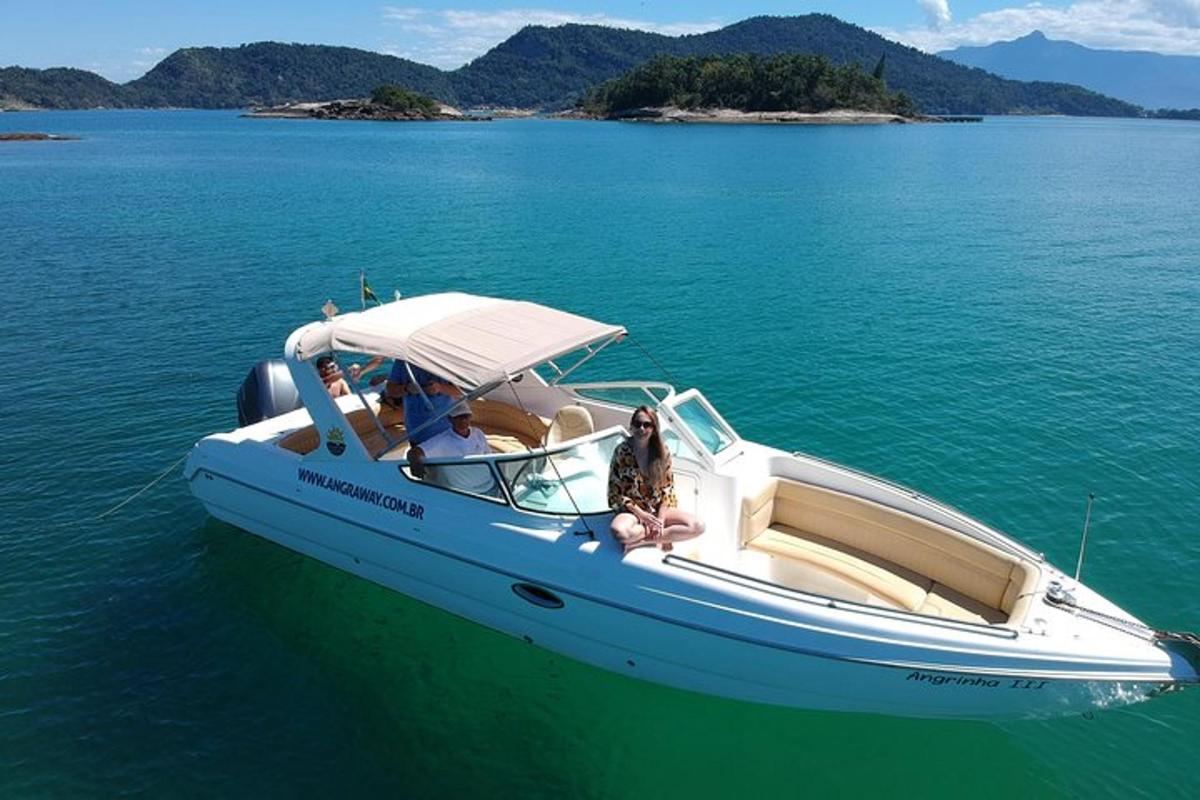 a man and a woman sitting on a boat in the water