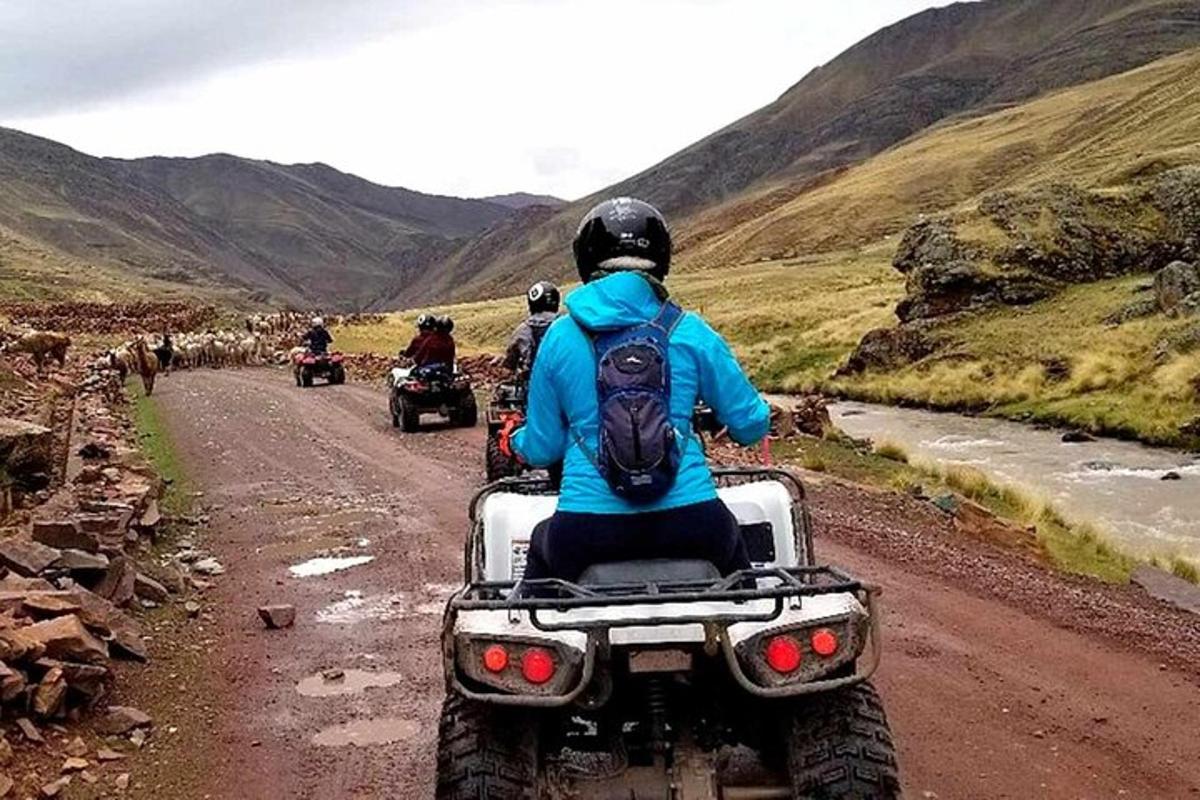 a group of people riding motorcycles on a dirt road