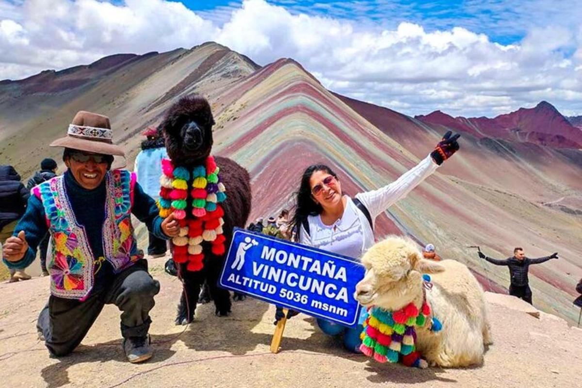 a man and a woman standing next to a mountain with a sign