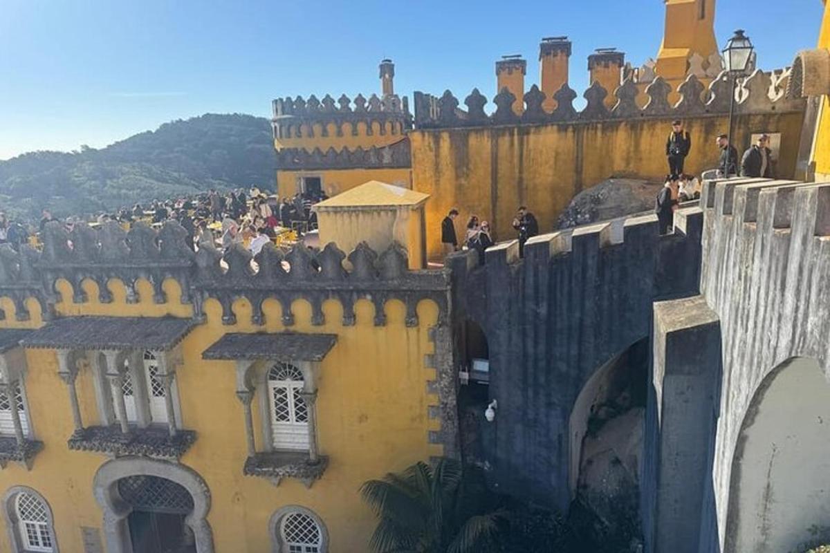 a group of people standing on top of a castle