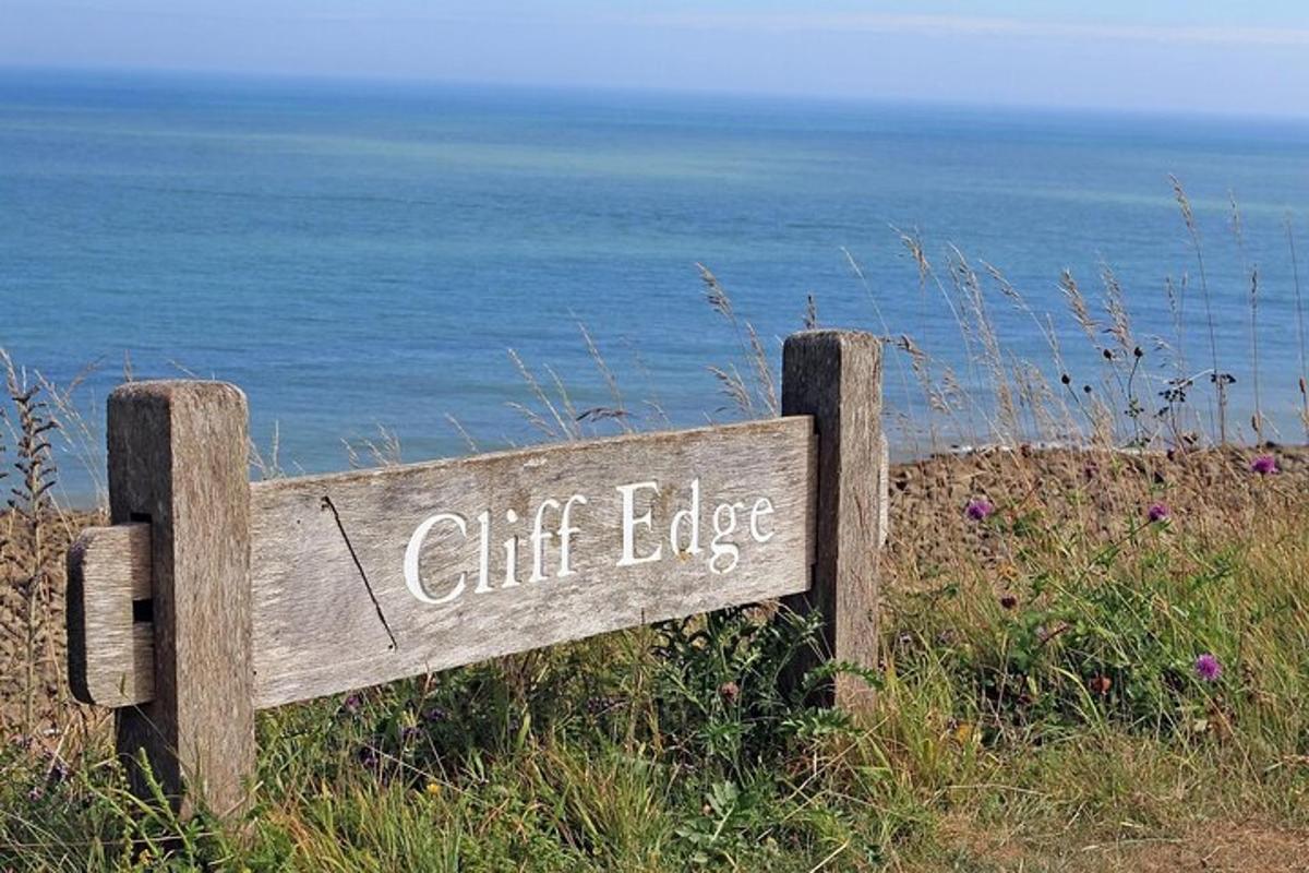 a wooden sign with the words cliff edge