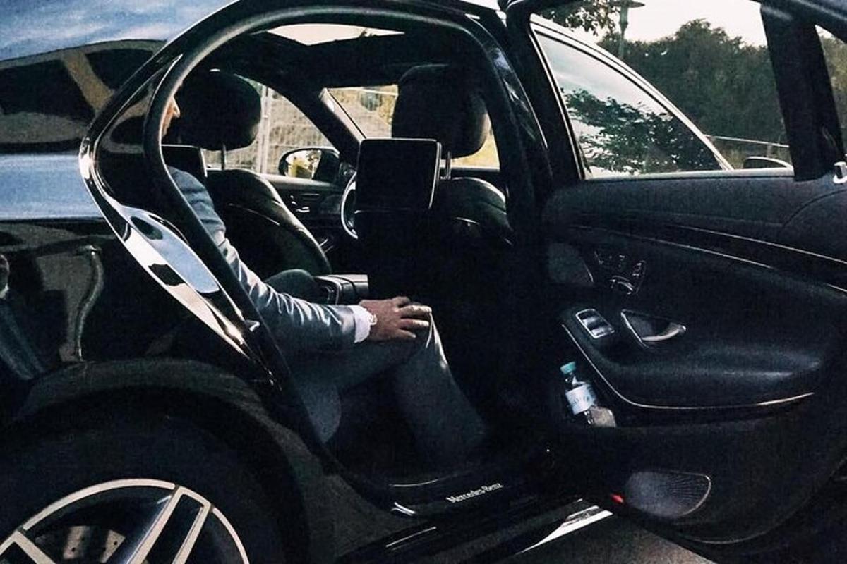a person sitting in the drivers seat of a car
