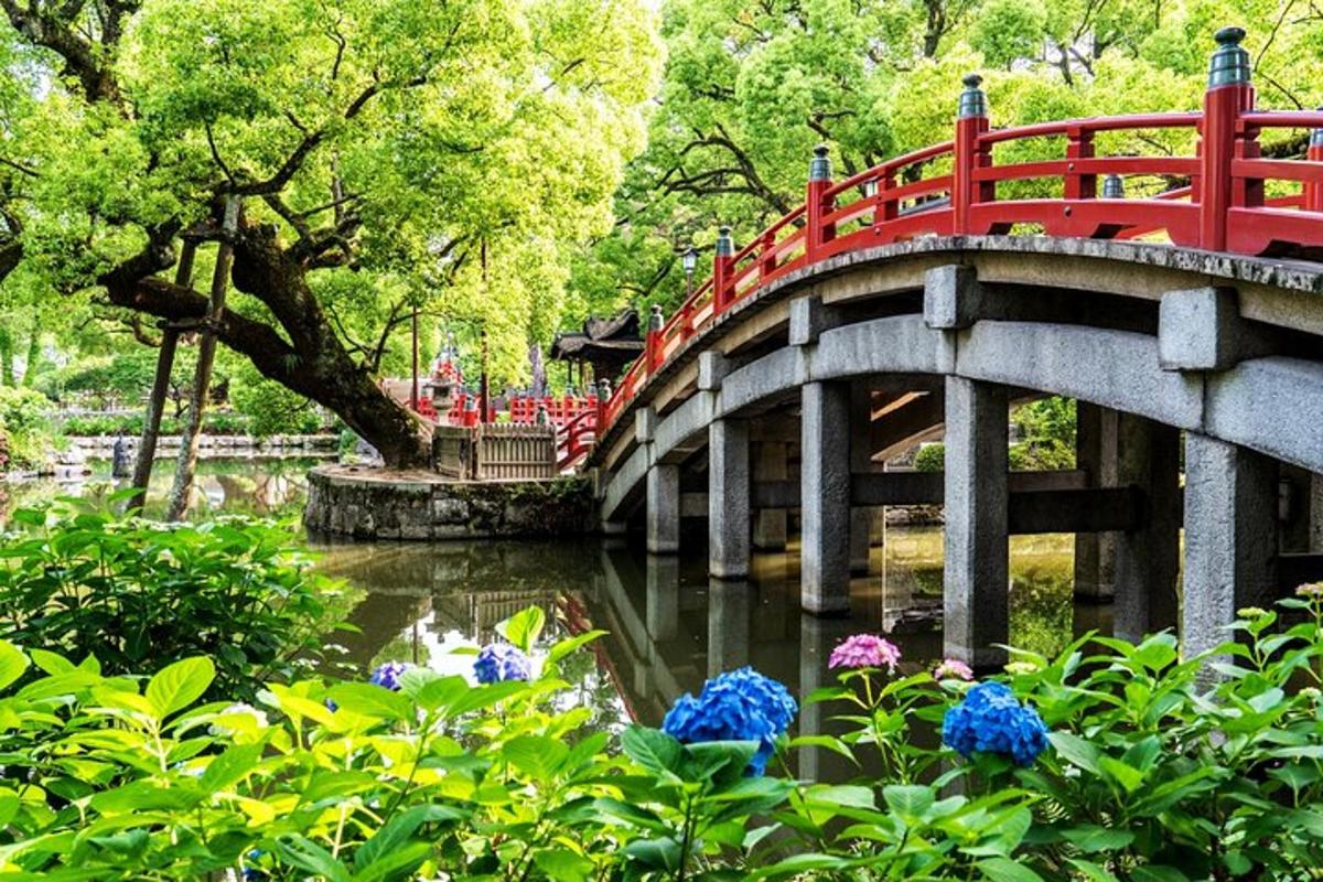 a red bridge over a pond in a park