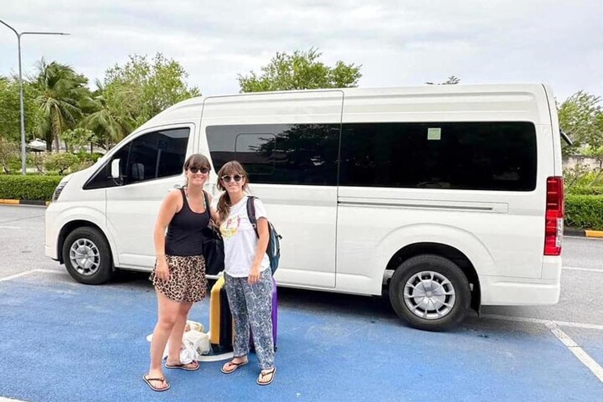 two women standing in front of a white van