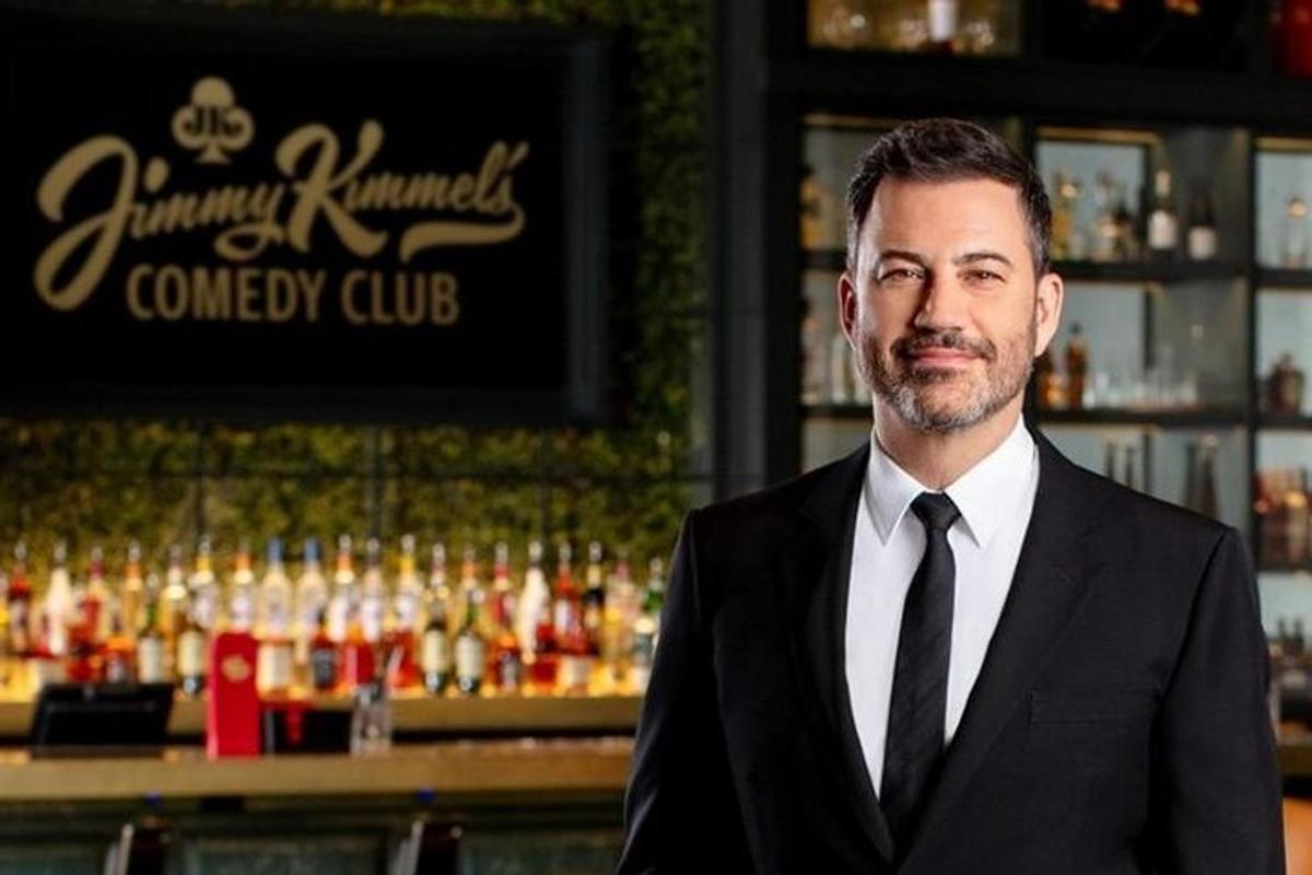 a man in a suit and tie standing in front of a bar