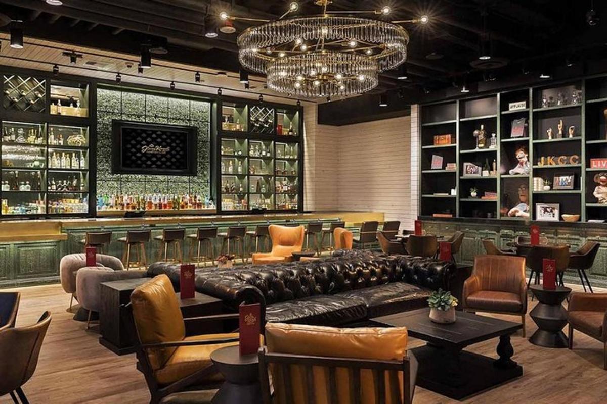 a bar with a leather couch in the middle of a room