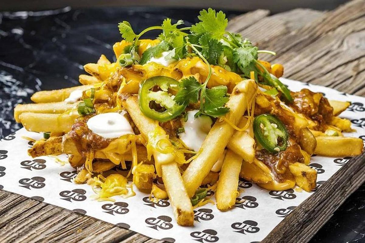 a plate of food with french fries on a table