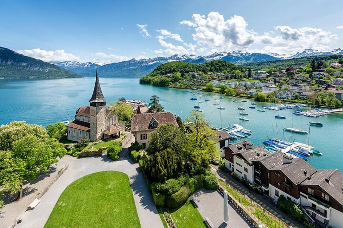 an aerial view of a town on the water with boats