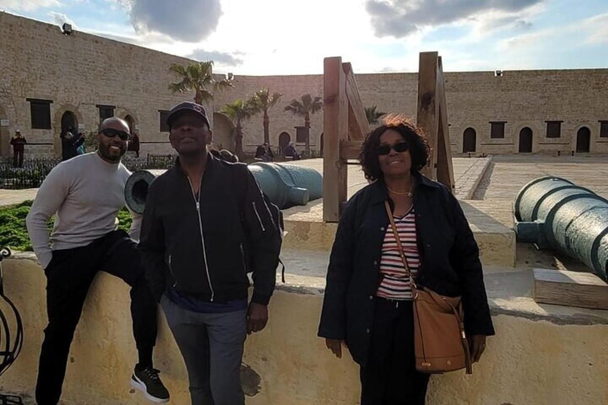 a group of three people standing in front of a building