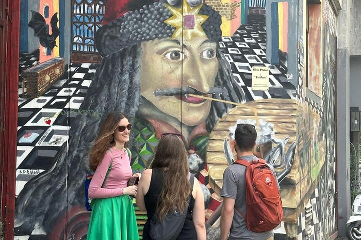 a group of people standing in front of a mural
