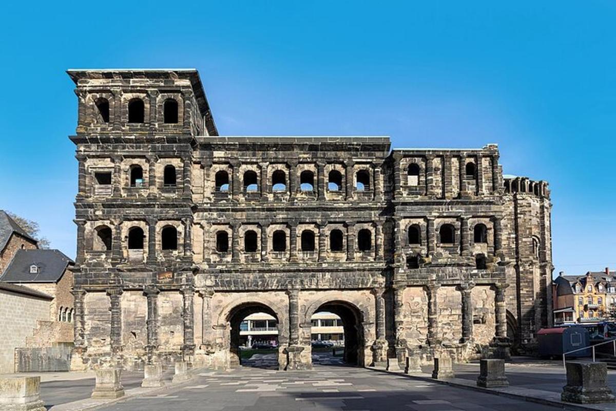 an old stone building with an arch in a city