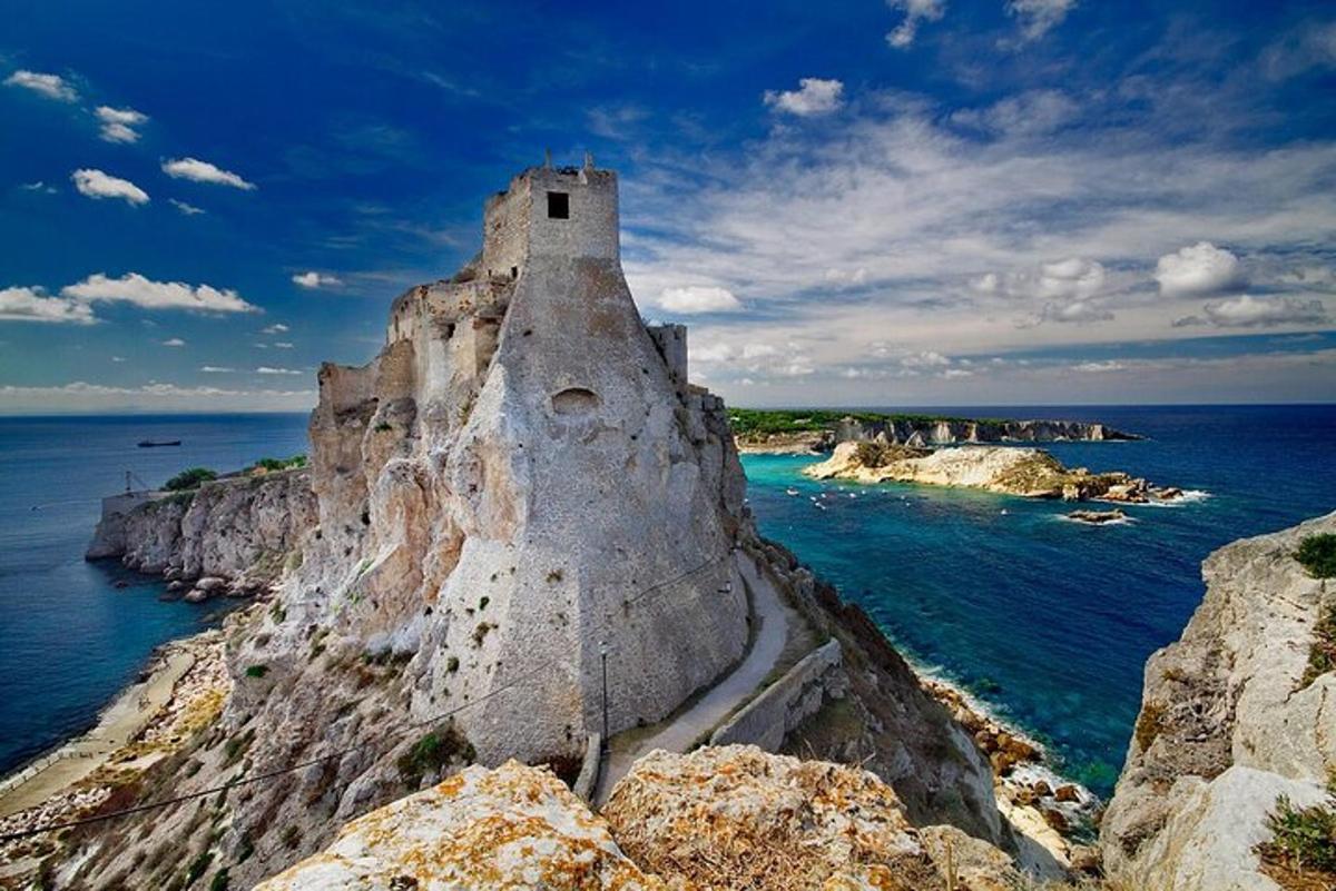 an old building on a cliff near the ocean
