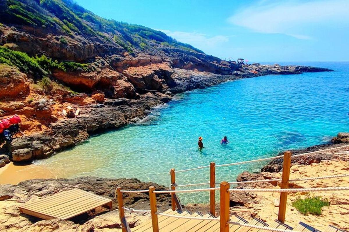 two people swimming in the water on a beach