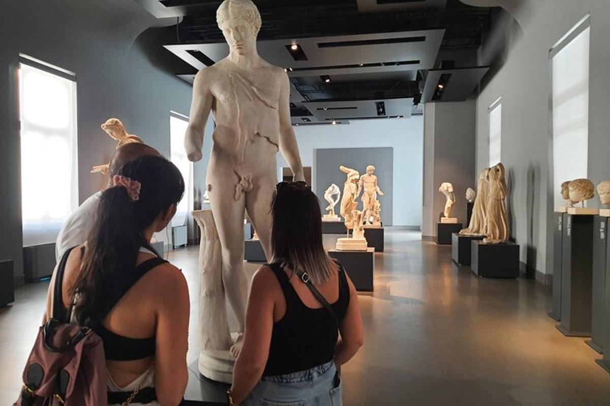 two women looking at a statue in a museum