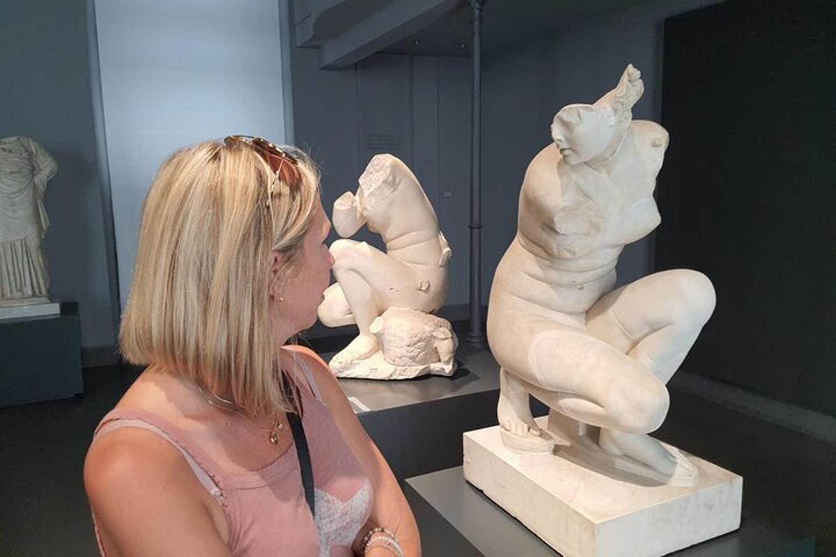 a woman looking at a sculpture in a museum