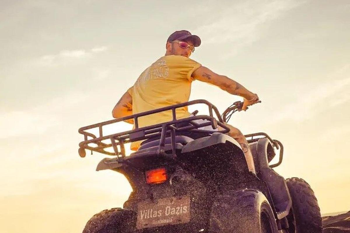 a man riding on the back of a four wheeler