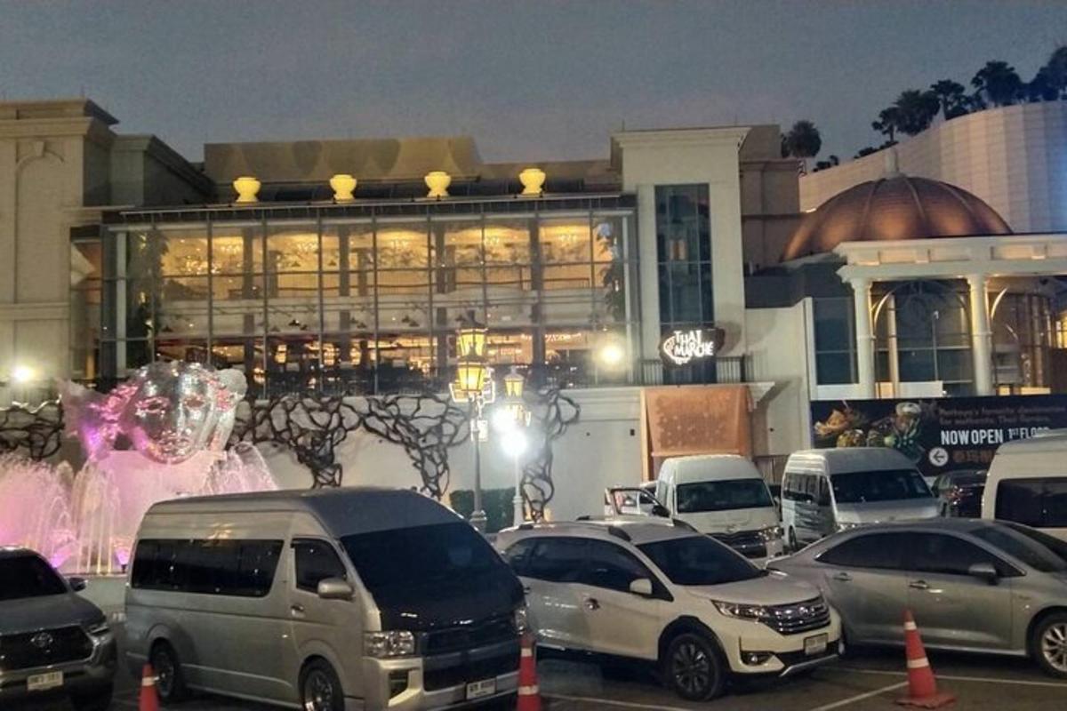 a parking lot with cars parked in front of a building