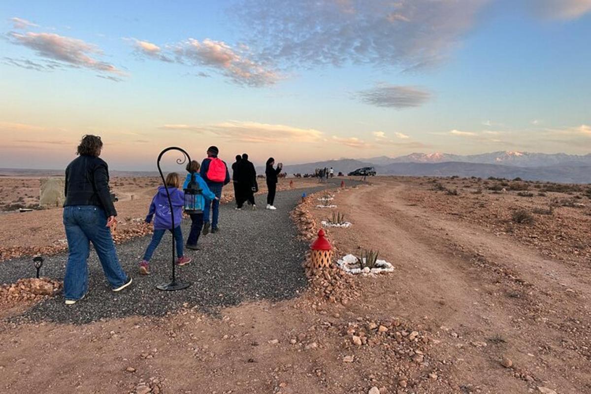 a group of people walking down a dirt road