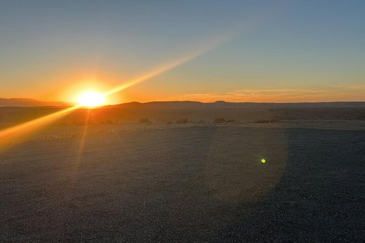 a sunset in the desert with the sun setting
