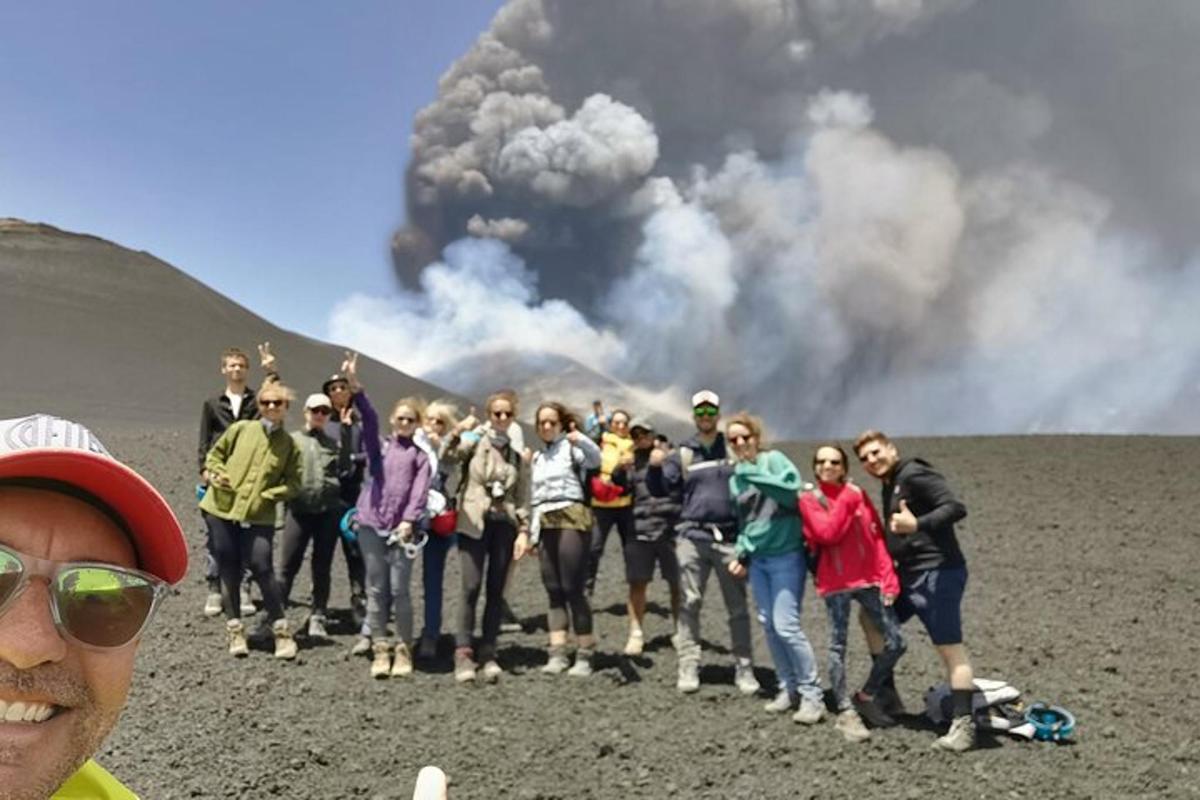 a group of people standing in front of a volcano
