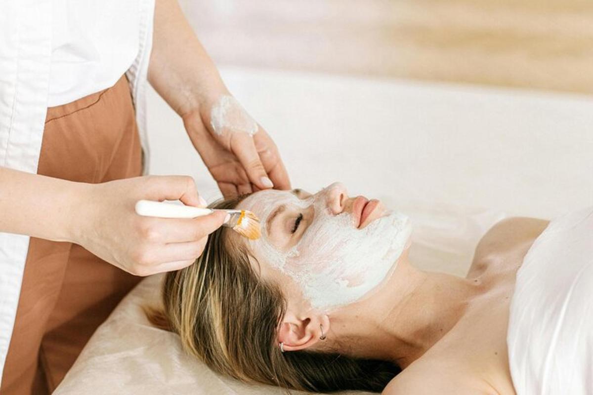 a woman getting a facial treatment at a spa
