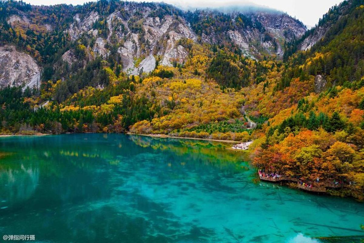 an aerial view of a lake in the mountains