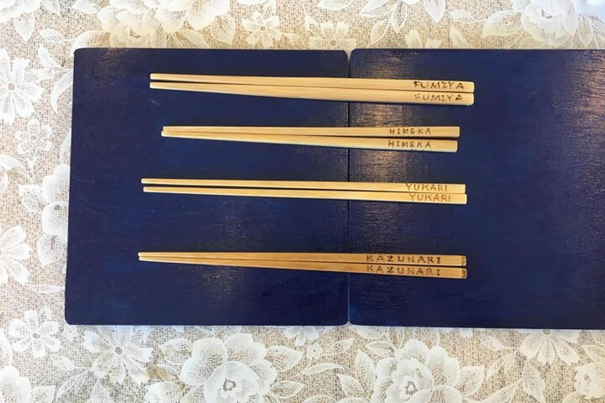 a black book with wooden chopsticks in it
