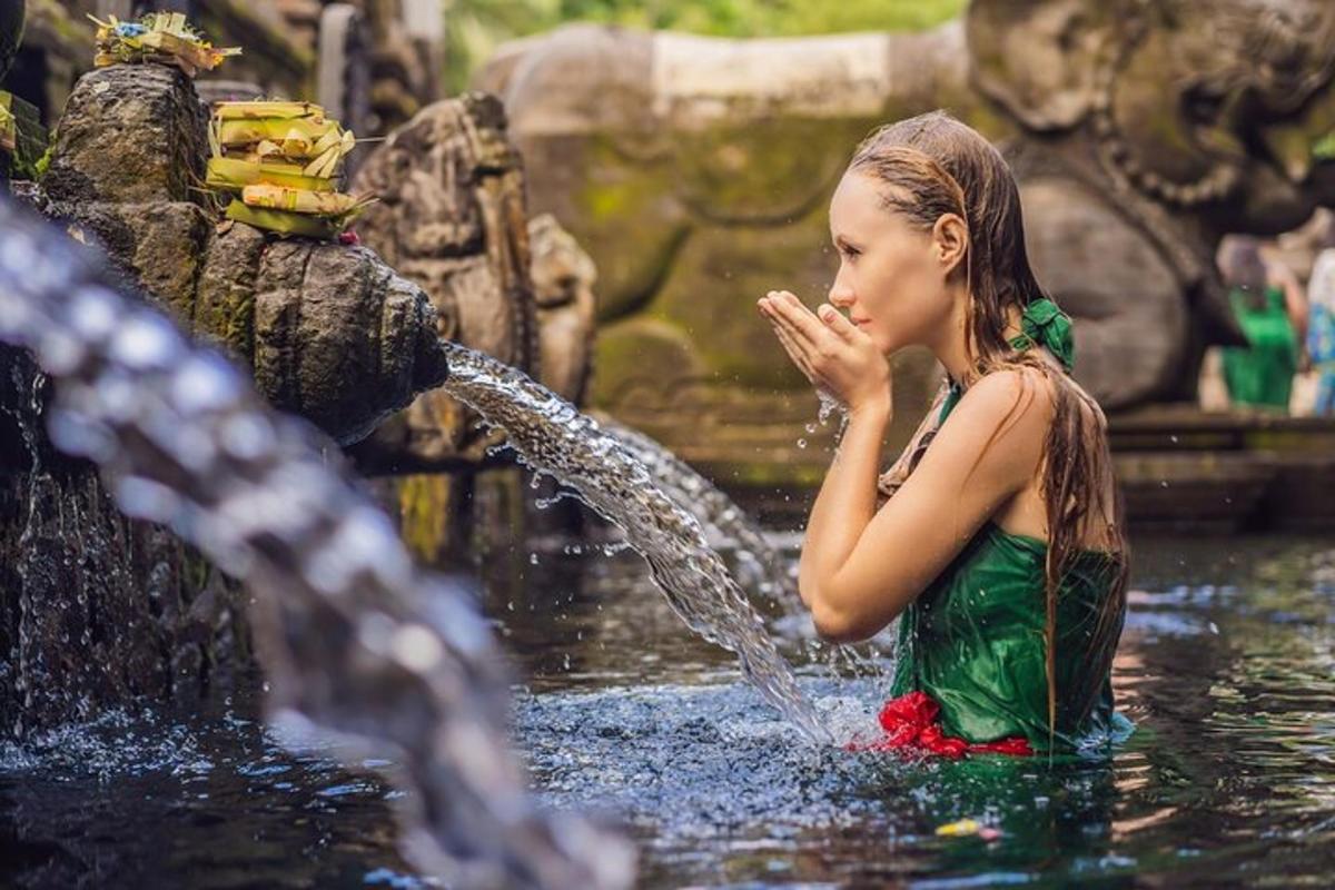 a young girl is playing in a fountain