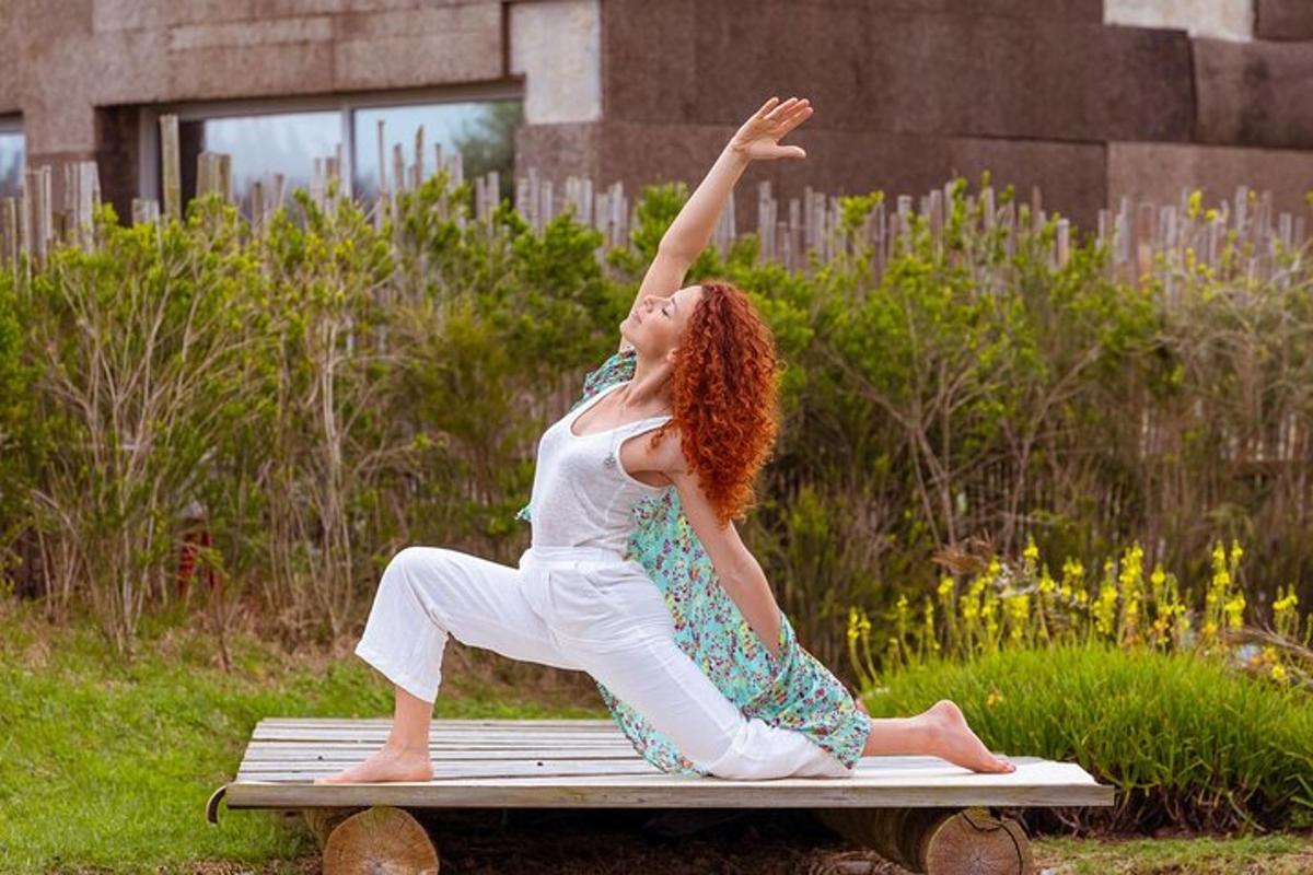 a woman sitting on a bench with her arm in the air