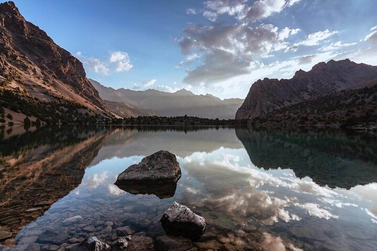 a view of a lake with rocks in the water