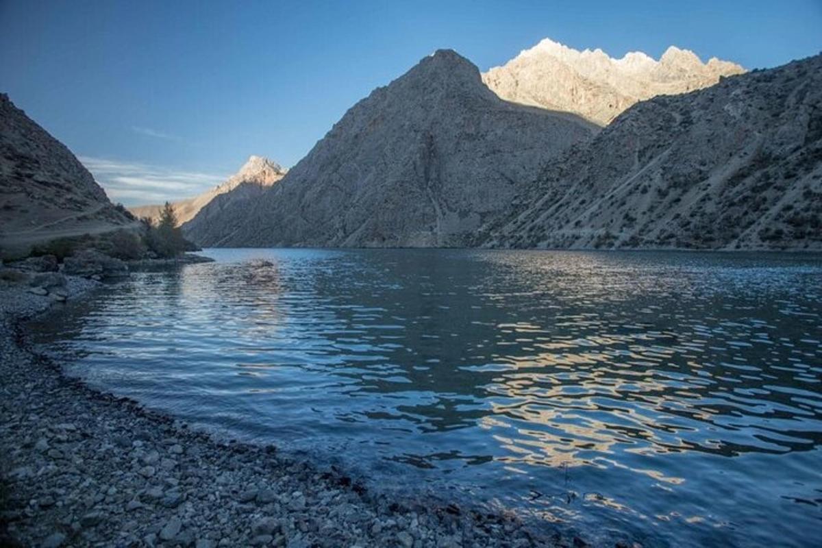 a large body of water with mountains in the background