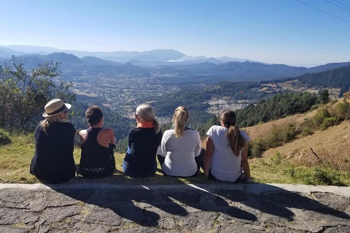 a group of people sitting on top of a mountain