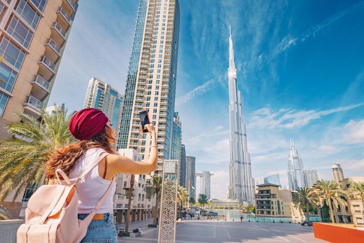a woman taking a picture of the dubai city