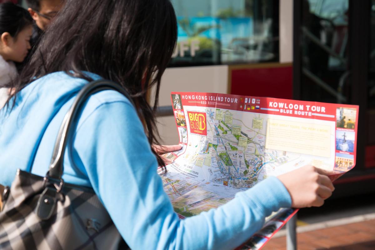 a woman is looking at a map