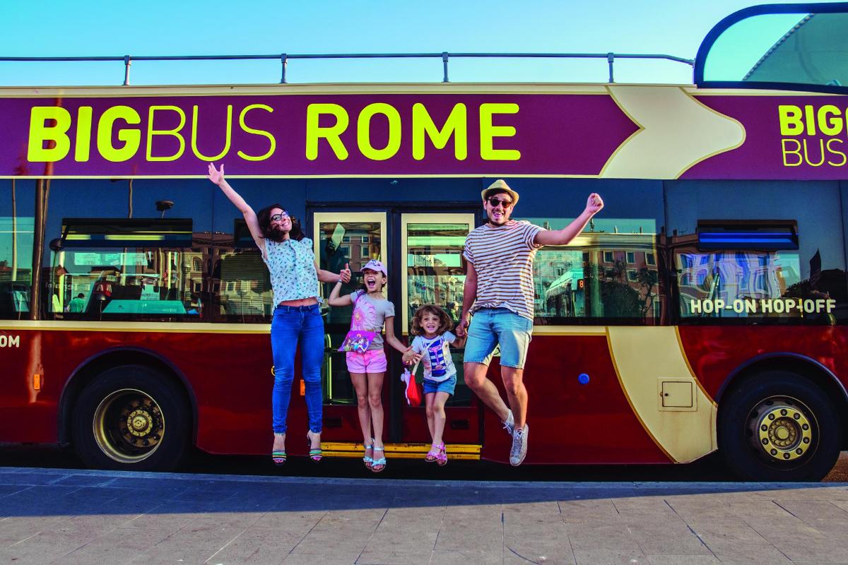 a family standing on the side of a bus
