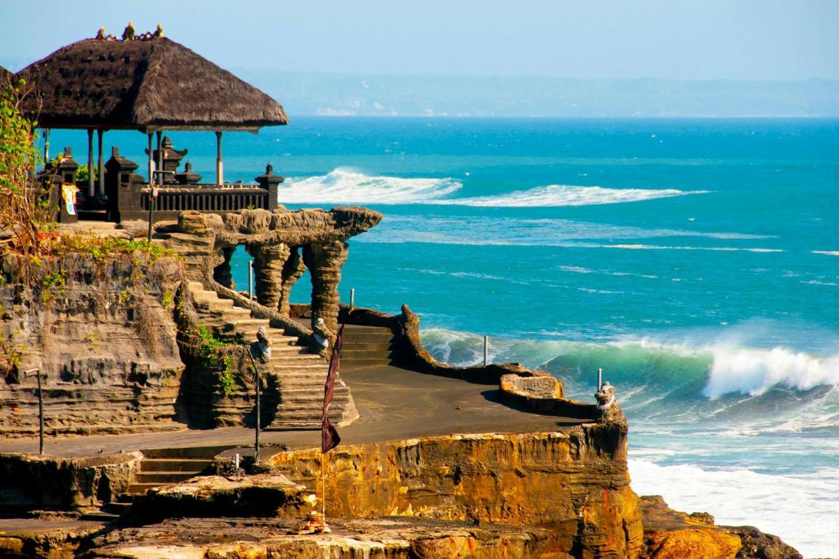 a view of the ocean from a cliff with a gazebo