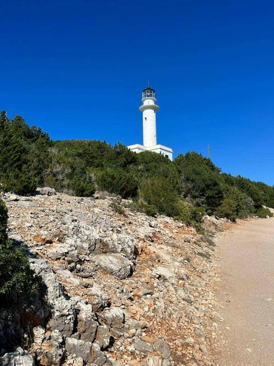 a lighthouse sitting on top of a hill