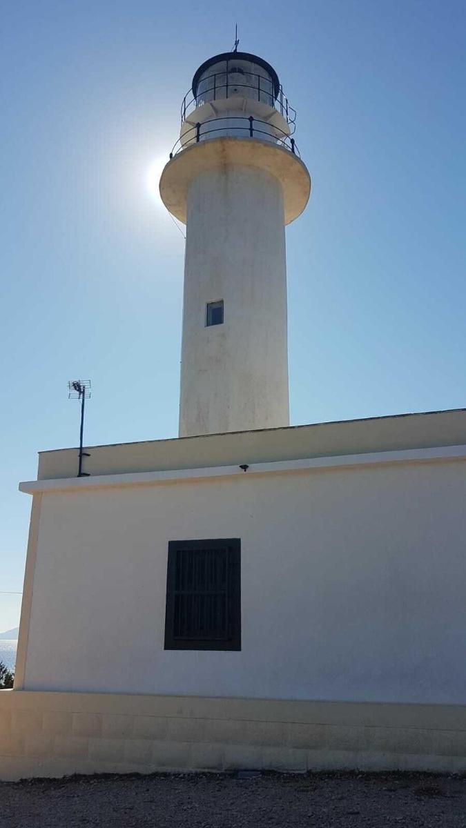 a lighthouse sitting on top of a white building